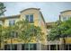 Lovely yellow condominium building with well-maintained landscaping, featuring mature trees at 1832 Telfair Way # 1832, Charleston, SC 29412