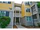 Charming yellow townhouse with dark shutters, beautiful columns, and a small garden at 1832 Telfair Way # 1832, Charleston, SC 29412