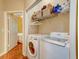 Convenient laundry room with modern washer and dryer units and shelving for storage at 1832 Telfair Way # 1832, Charleston, SC 29412