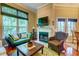Bright living room with a fireplace, large windows, hardwood floors, and comfortable woven chair at 1832 Telfair Way # 1832, Charleston, SC 29412