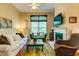 Inviting living room features a cozy fireplace, comfortable seating, and natural light from a large window at 1832 Telfair Way # 1832, Charleston, SC 29412