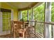 Enchanting screened porch with an outdoor dining table, a ceiling fan, and views of natural landscape at 1832 Telfair Way # 1832, Charleston, SC 29412