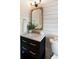 Stylish bathroom with a dark vanity, gold hardware, framed mirror, and shiplap accent wall at 193 Corn Planters St, Charleston, SC 29492