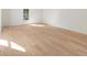 This empty room has hardwood flooring and a bright sunny window facing a leafy view at 193 Corn Planters St, Charleston, SC 29492