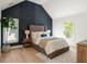 Beautifully decorated bedroom featuring a textured accent wall and light wood flooring at 193 Corn Planters St, Charleston, SC 29492