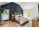 Beautifully decorated bedroom featuring a textured accent wall and light wood flooring at 193 Corn Planters St, Charleston, SC 29492