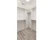An organized walk-in closet with built in shelves and drawers for storage and light wood flooring at 193 Corn Planters St, Charleston, SC 29492