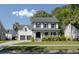 Charming two-story home with a welcoming front porch, lush lawn, and manicured landscaping at 193 Corn Planters St, Charleston, SC 29492