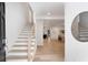 Bright foyer with light wood floors, open staircase, and views into the adjacent living spaces at 193 Corn Planters St, Charleston, SC 29492