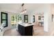 Well-lit kitchen with a central island, quartz countertops, and access to the outdoor patio at 193 Corn Planters St, Charleston, SC 29492