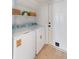 Functional laundry room with washer, dryer, storage shelves, and an exterior door at 193 Corn Planters St, Charleston, SC 29492