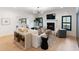 Bright living room with shiplap fireplace, modern furnishings, and seamless flow to dining area at 193 Corn Planters St, Charleston, SC 29492