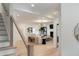 View from the stairs into the open-concept living room and dining area with lots of natural light at 193 Corn Planters St, Charleston, SC 29492