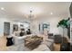 Open-concept living room flowing into the kitchen, featuring hardwood floors and bright, natural light at 193 Corn Planters St, Charleston, SC 29492