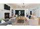 Bright and stylish living room featuring a fireplace, shiplap accent wall, and modern furnishings at 193 Corn Planters St, Charleston, SC 29492