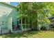 Picture of the home's lush backyard with a wooden porch, green lawn, and mature trees for shade at 2010 Coldspring Dr # 502, North Charleston, SC 29406
