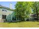 View of the home's backyard with a wooden porch, green lawn, and mature trees offering plenty of shade at 2010 Coldspring Dr # 502, North Charleston, SC 29406
