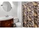 Cozy bathroom offers a classic style with patterned shower curtain and a dark wood vanity at 2010 Coldspring Dr # 502, North Charleston, SC 29406