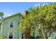 Close-up of a light-green condo, brick chimney, and surrounding greenery, showcasing the home's natural setting at 2010 Coldspring Dr # 502, North Charleston, SC 29406