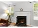 Bright fireplace with decorative mantle and hearth, flanked by windows with bright natural light at 2010 Coldspring Dr # 502, North Charleston, SC 29406