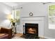 Bright fireplace with decorative mantle and hearth, flanked by windows with bright natural light at 2010 Coldspring Dr # 502, North Charleston, SC 29406