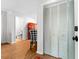 Bright hallway with wood floors, a sliding closet, and a view into a pristine bathroom and tastefully decorated room at 2010 Coldspring Dr # 502, North Charleston, SC 29406