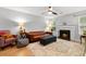 Cozy living room with hardwood floors, stylish rug, brown leather couch and fireplace at 2010 Coldspring Dr # 502, North Charleston, SC 29406