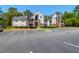 Condominium exterior with parking spaces, palm trees, and well-kept lawn at 2011 N Highway 17 # 1400T, Mount Pleasant, SC 29466