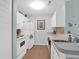 Galley kitchen with all-white appliances, lots of storage, and hardwood floors at 2011 N Highway 17 # 1400T, Mount Pleasant, SC 29466