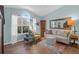 Comfortable living room with large windows, hardwood floors, and a stylish sofa at 2011 N Highway 17 # 1400T, Mount Pleasant, SC 29466
