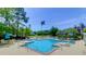 Relaxing community pool area with lounge chairs, tables with umbrellas, and mature trees on a sunny day at 2011 N Highway 17 # 1400T, Mount Pleasant, SC 29466