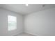 A clean, well-lit bedroom with neutral carpet, one window, and minimalist design at 202 W Bradford Pointe Drive Dr, Summerville, SC 29483