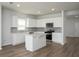 Open kitchen with white cabinets, stainless steel appliances, center island, and a view to the living area at 202 W Bradford Pointe Drive Dr, Summerville, SC 29483