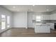 Bright, airy kitchen with white cabinets, a center island, stainless steel appliances, and access to the backyard at 202 W Bradford Pointe Drive Dr, Summerville, SC 29483