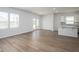 Bright open floor plan with light wood floors, lots of light, a patio door and a view into the kitchen at 202 W Bradford Pointe Drive Dr, Summerville, SC 29483