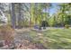 Landscaped backyard featuring mature trees, a seating area and view of the property at 210 Peters St, Summerville, SC 29483