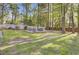 Spacious backyard featuring a lush lawn and wooded area. and outdoor furniture at 210 Peters St, Summerville, SC 29483