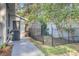 Backyard view showcasing a greenhouse, storage area, and fencing surrounding the property at 210 Peters St, Summerville, SC 29483