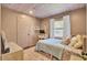 Charming bedroom with patterned wallpaper, filled with natural light and comfortable furniture at 210 Peters St, Summerville, SC 29483