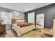 Sunlit bedroom with large windows, hardwood floors, area rug, and neutral color palette at 210 Peters St, Summerville, SC 29483