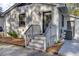 Charming front entrance with a white brick facade, accented by black trim and a covered porch at 210 Peters St, Summerville, SC 29483