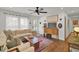 Bright living room featuring hardwood floors, large windows, comfortable seating, and stylish decor at 210 Peters St, Summerville, SC 29483