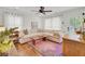 Bright living room with white walls, hardwood floors, and a colorful area rug at 210 Peters St, Summerville, SC 29483