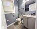 Cozy bathroom featuring blue walls, a white toilet, sink, and vanity at 2125 Victory Ave, North Charleston, SC 29405