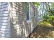 Side view of the home showing the siding and exterior details, including a small window at 2125 Victory Ave, North Charleston, SC 29405