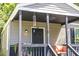 Close-up of the home's front porch featuring seating, a wind chime, and the house number at 2125 Victory Ave, North Charleston, SC 29405