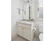 Cozy bathroom with a white vanity, toilet, and patterned tile flooring beneath a window with natural light at 22 Frogmore Rd, Mount Pleasant, SC 29464