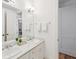 Bright bathroom featuring double sinks with white cabinets and marble countertops at 22 Frogmore Rd, Mount Pleasant, SC 29464