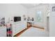 Bright bedroom with a desk, TV, and a large window providing natural light, creating a cozy space at 22 Frogmore Rd, Mount Pleasant, SC 29464