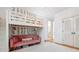 Unique bedroom features a lofted bed over a cozy pink couch, complemented by soft lighting and a plush white rug at 22 Frogmore Rd, Mount Pleasant, SC 29464